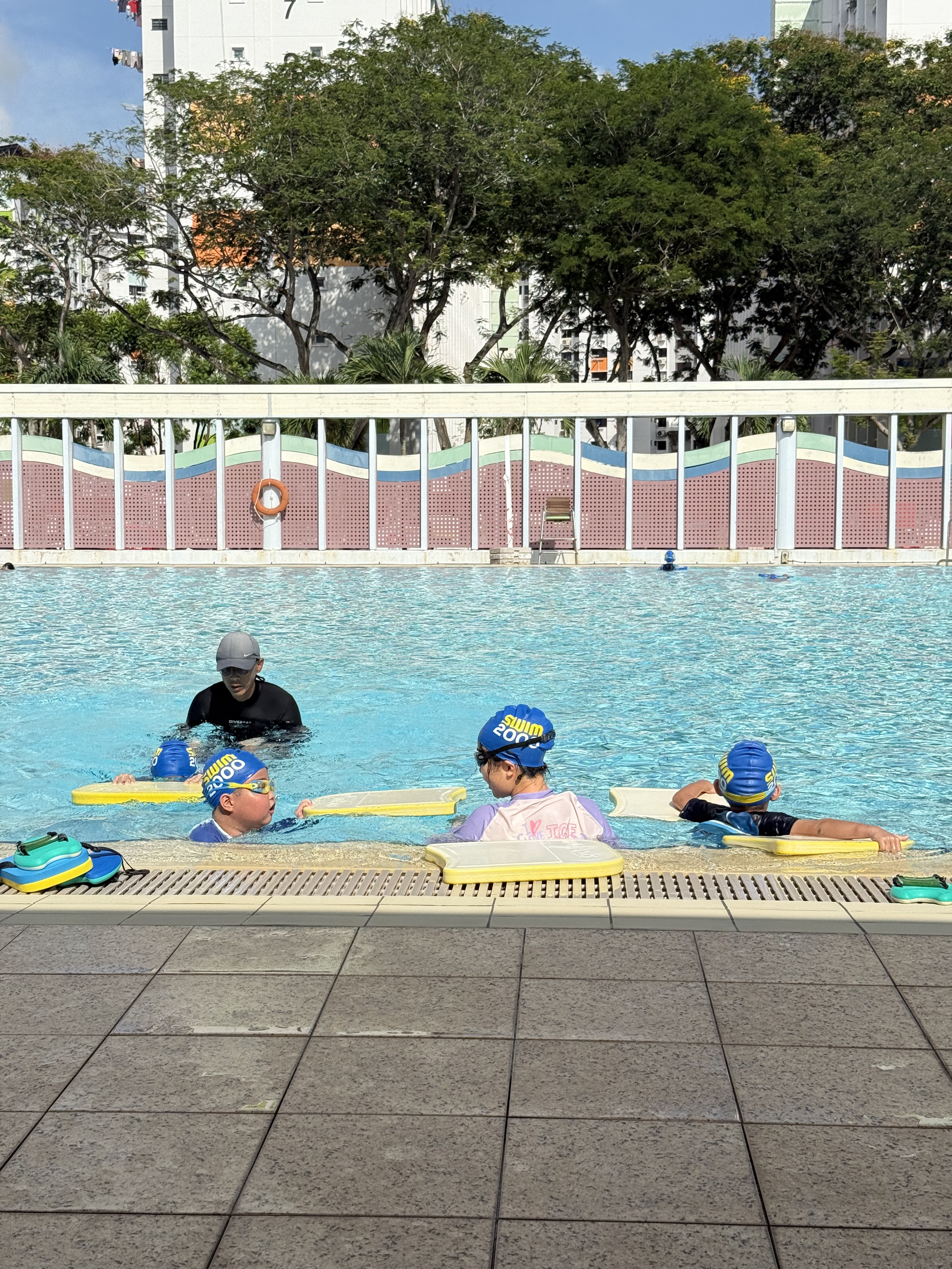 Coach David Lim correcting student breaststroke technique at Yishun Swimming Complex