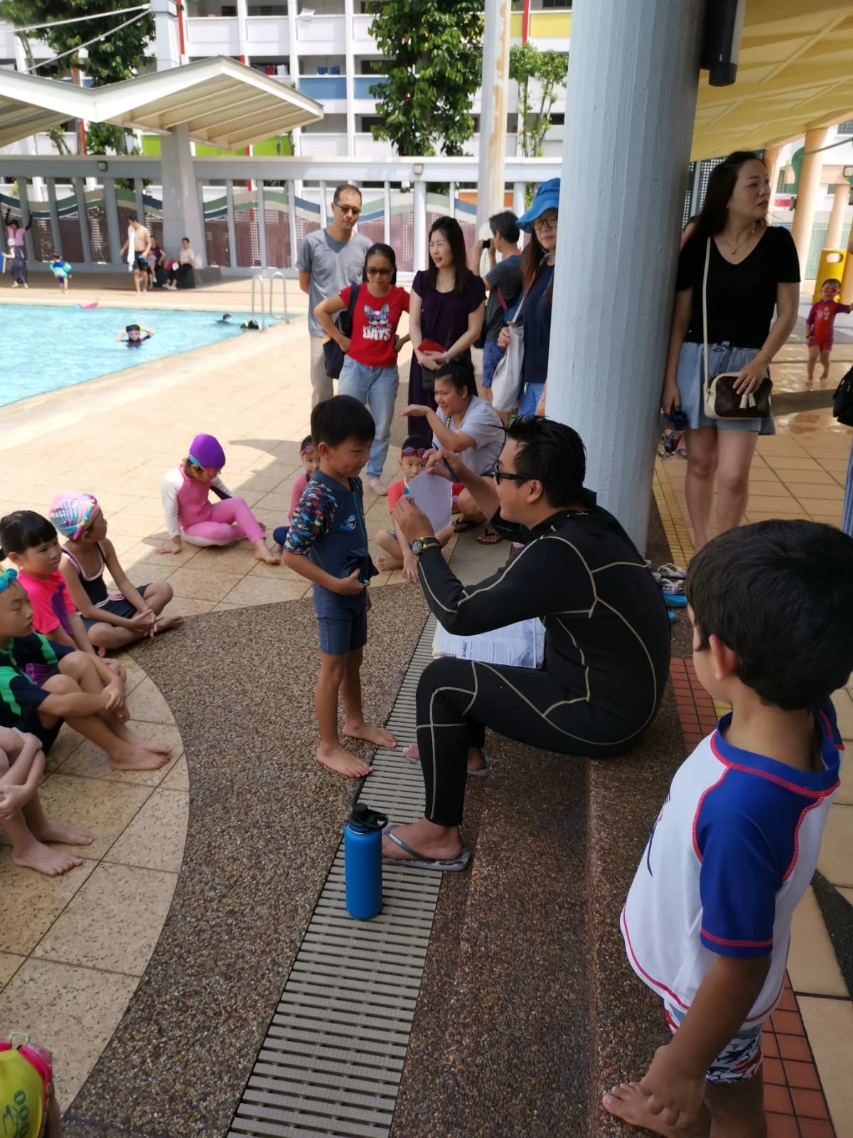 Coach Yucong briefing young swimmers at Yishun pool, 2020 SwimSafer test day